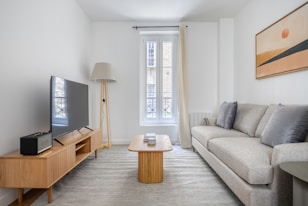 a living room filled with furniture and a flat screen tv