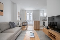 a living room filled with furniture and a flat screen tv