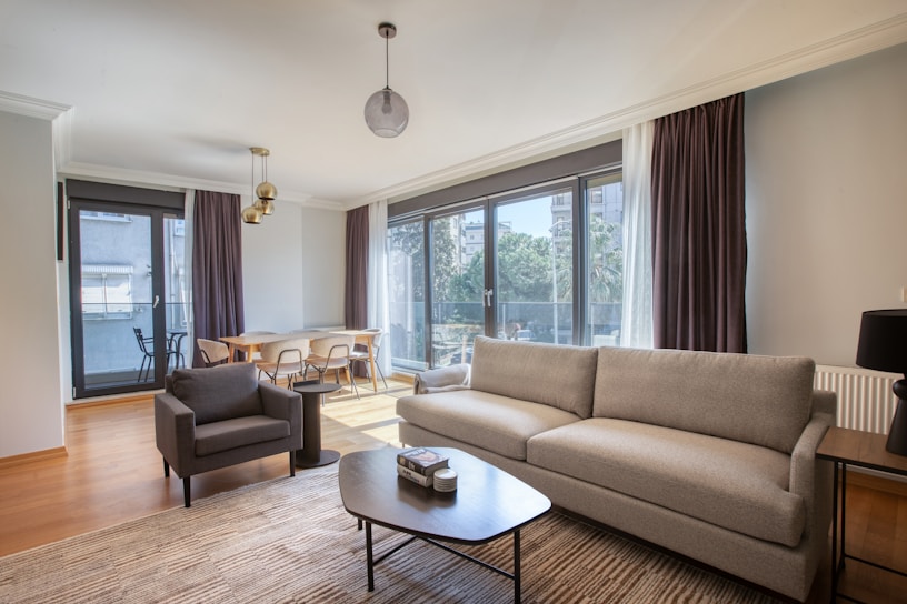 a living room filled with furniture and a large window