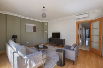 a living room filled with furniture and a flat screen tv