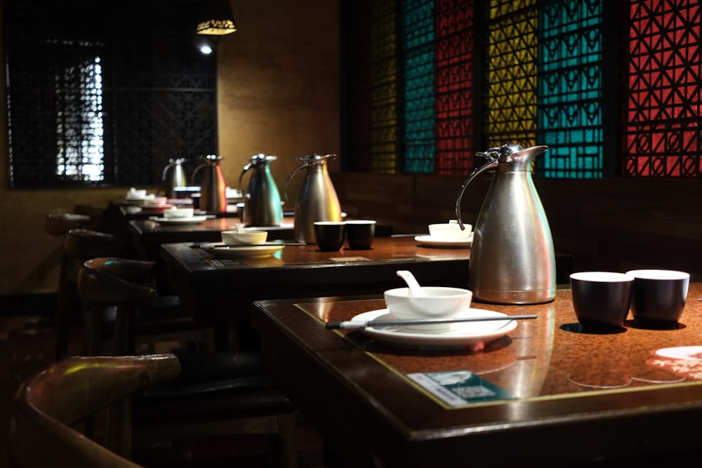 a table with a tea pot and cups on it