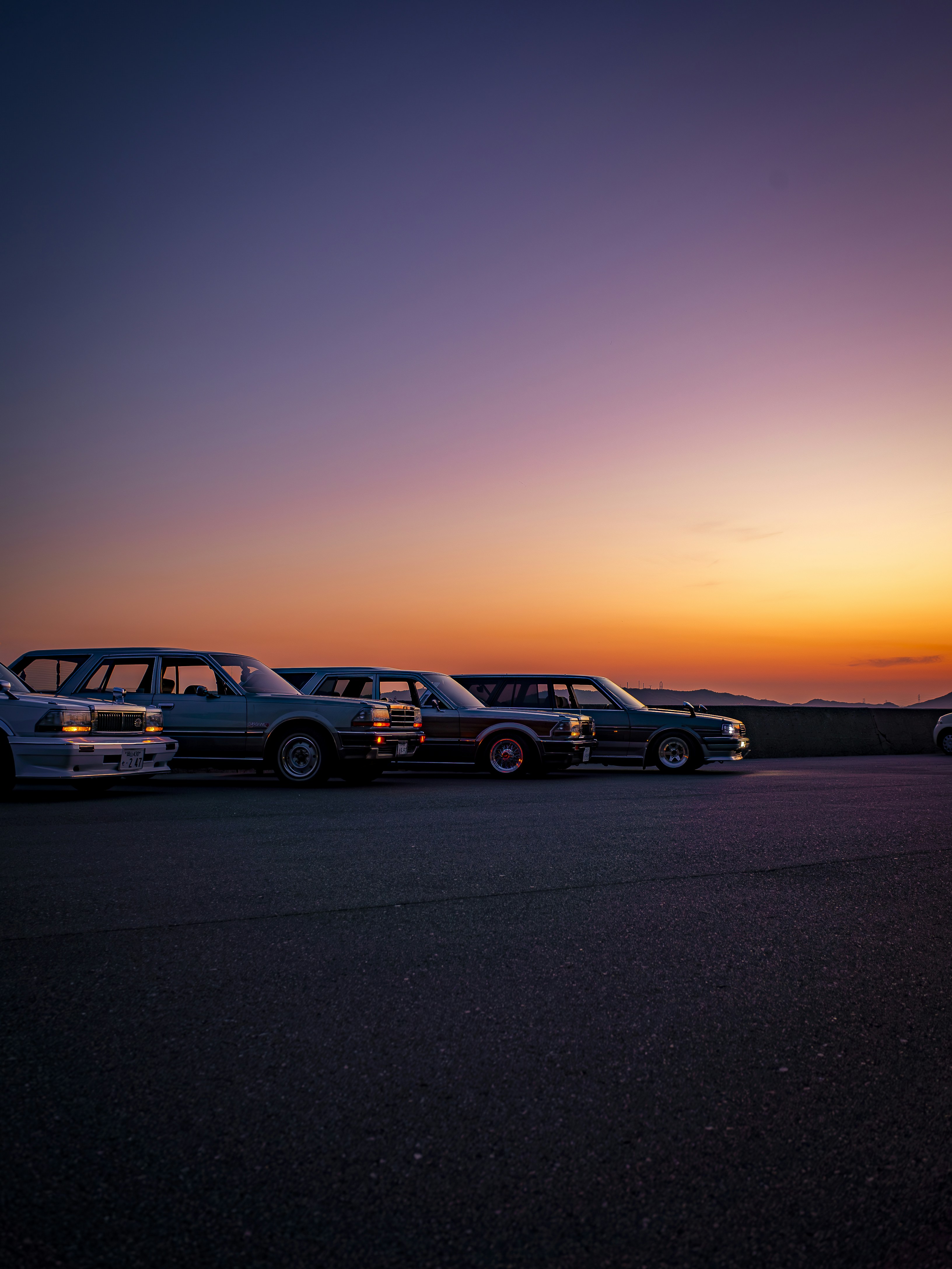 A group of cars parked next to each other in a parking lot photo – Free ...