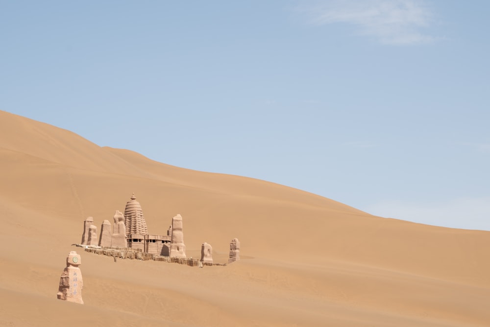a desert scene with a building in the middle of the desert