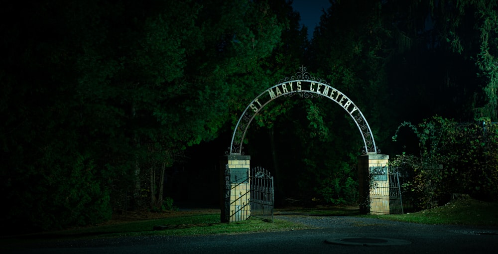 a night time photo of an entrance to a park