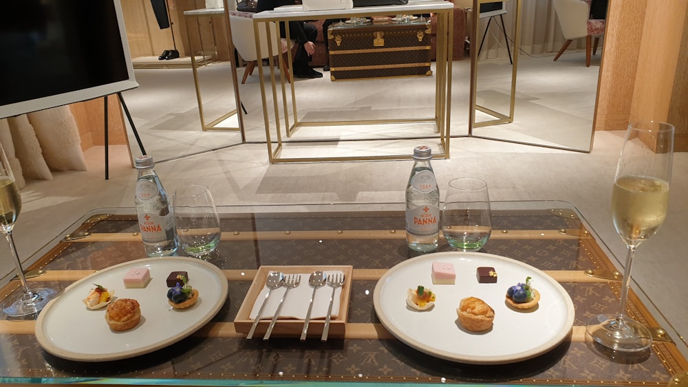 a glass table topped with two plates of food