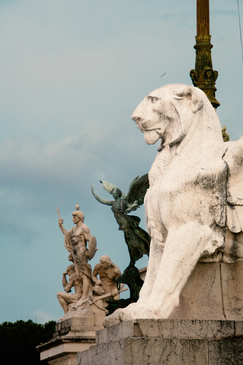 a statue of a lion with a cross in the background