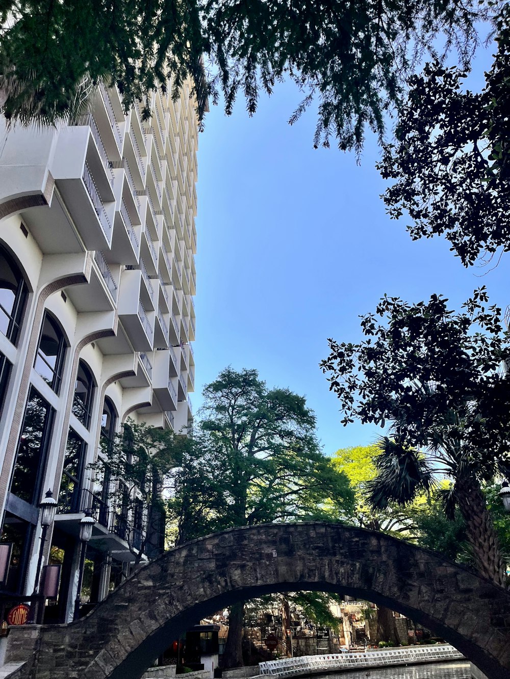 a bridge over a body of water next to a tall building