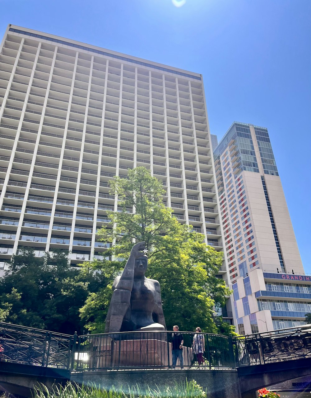 a statue of a man in front of a tall building