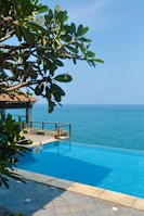 a large swimming pool with a view of the ocean