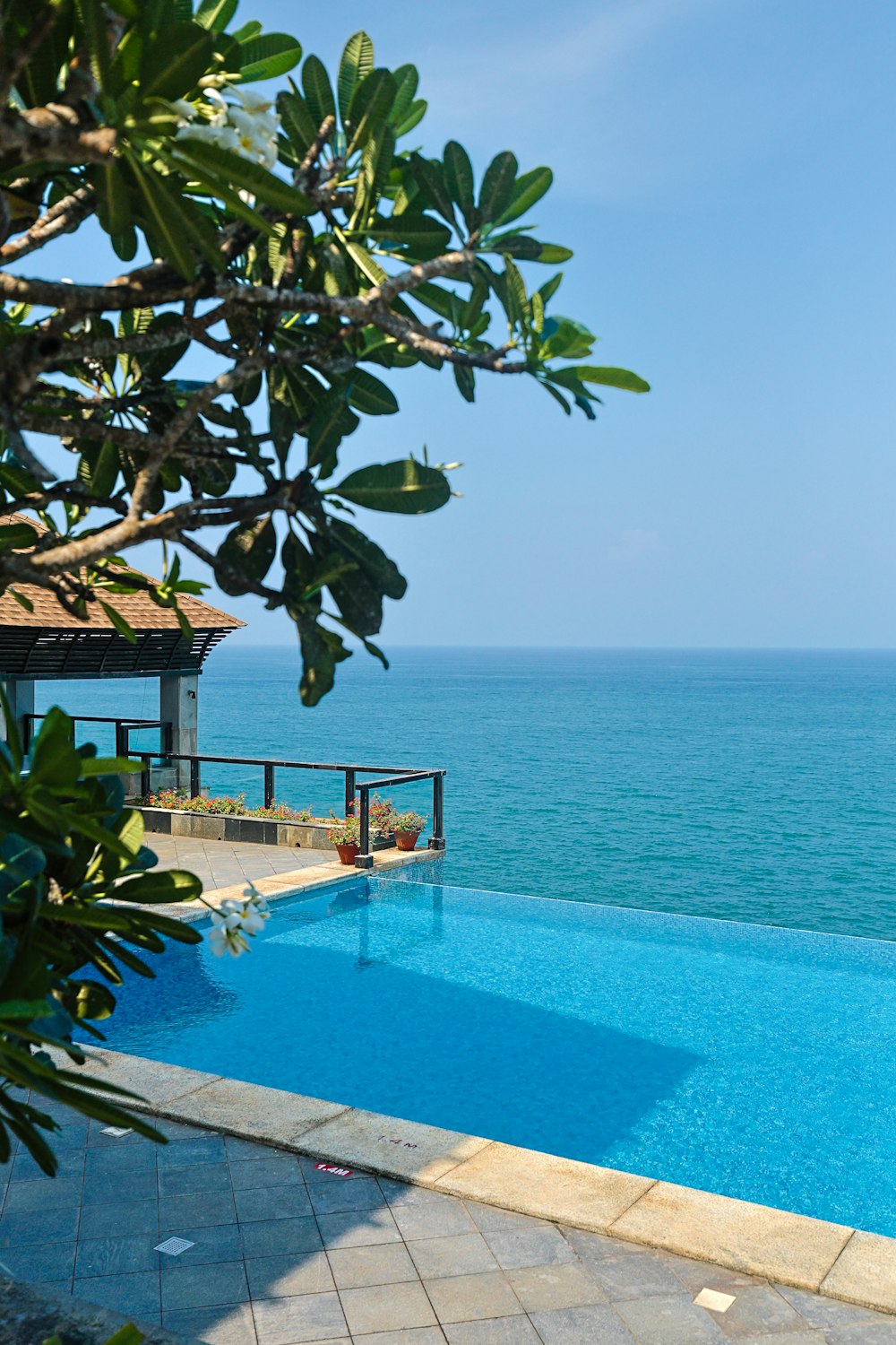 a large swimming pool with a view of the ocean