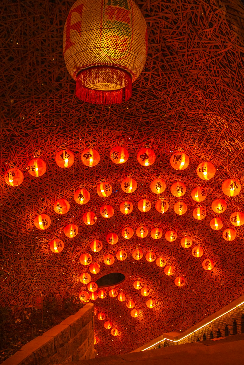 a room filled with lots of lit up lanterns