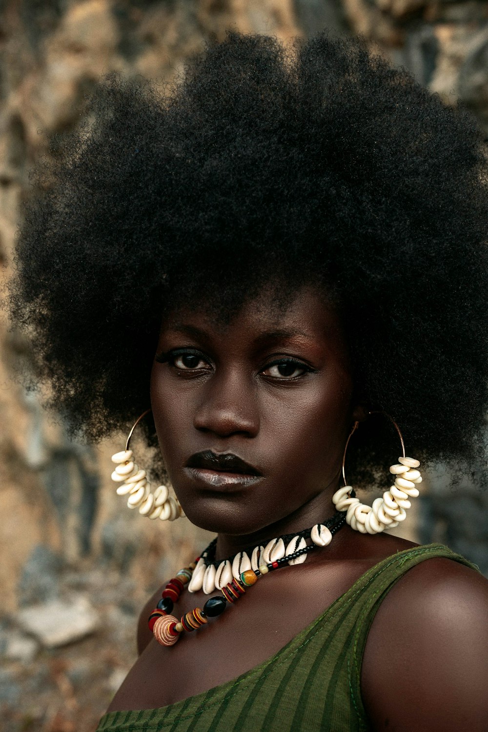 a woman with an afro and large earrings