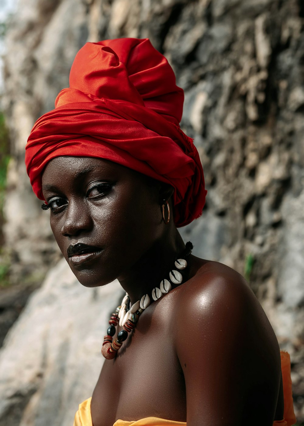 a woman with a red turban on her head