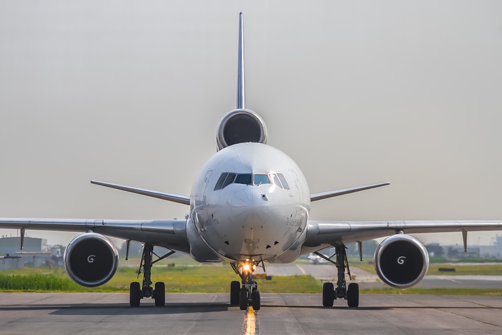 a large jetliner sitting on top of an airport runway