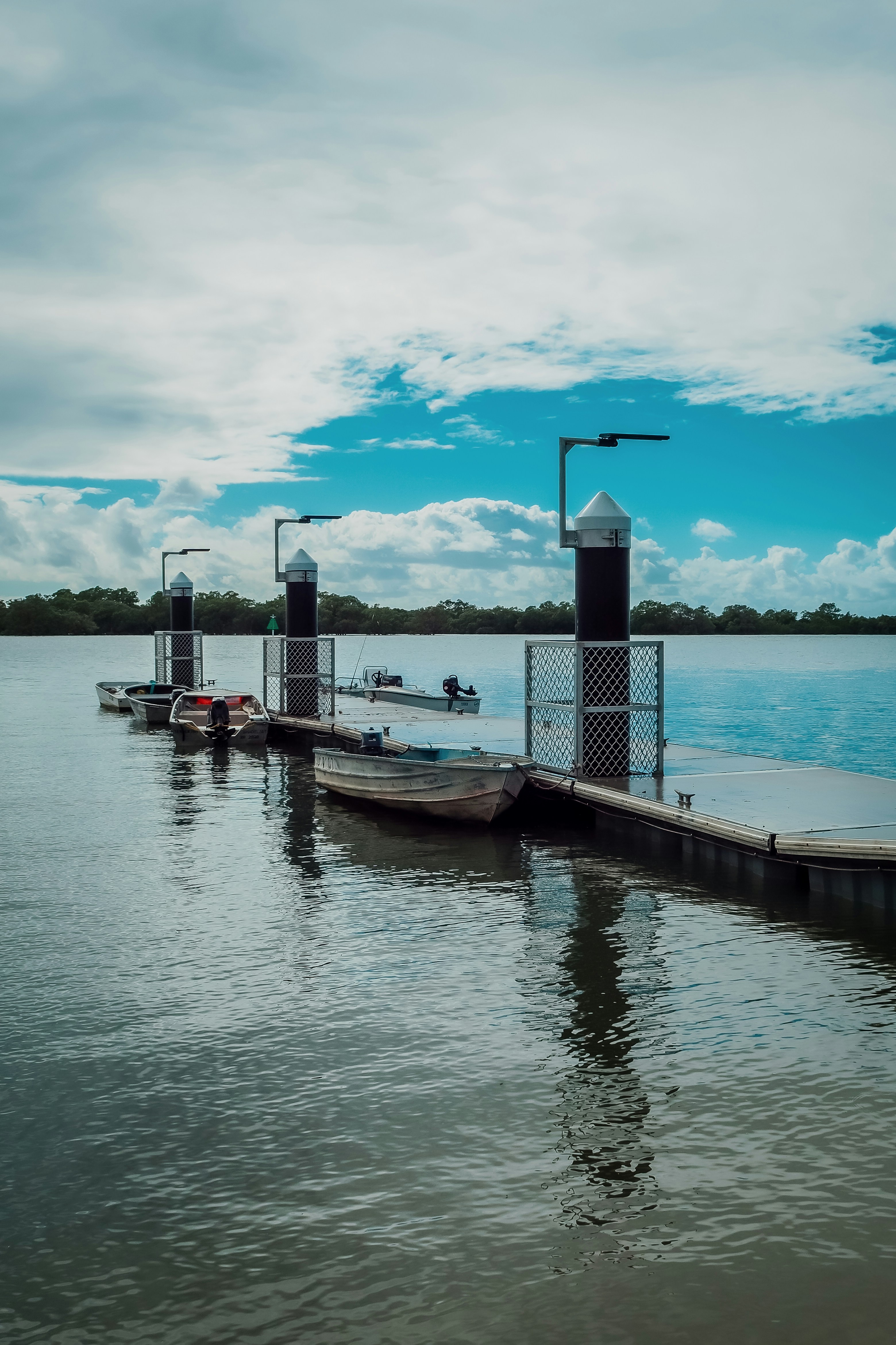 a dock on a lake with several boats in the water