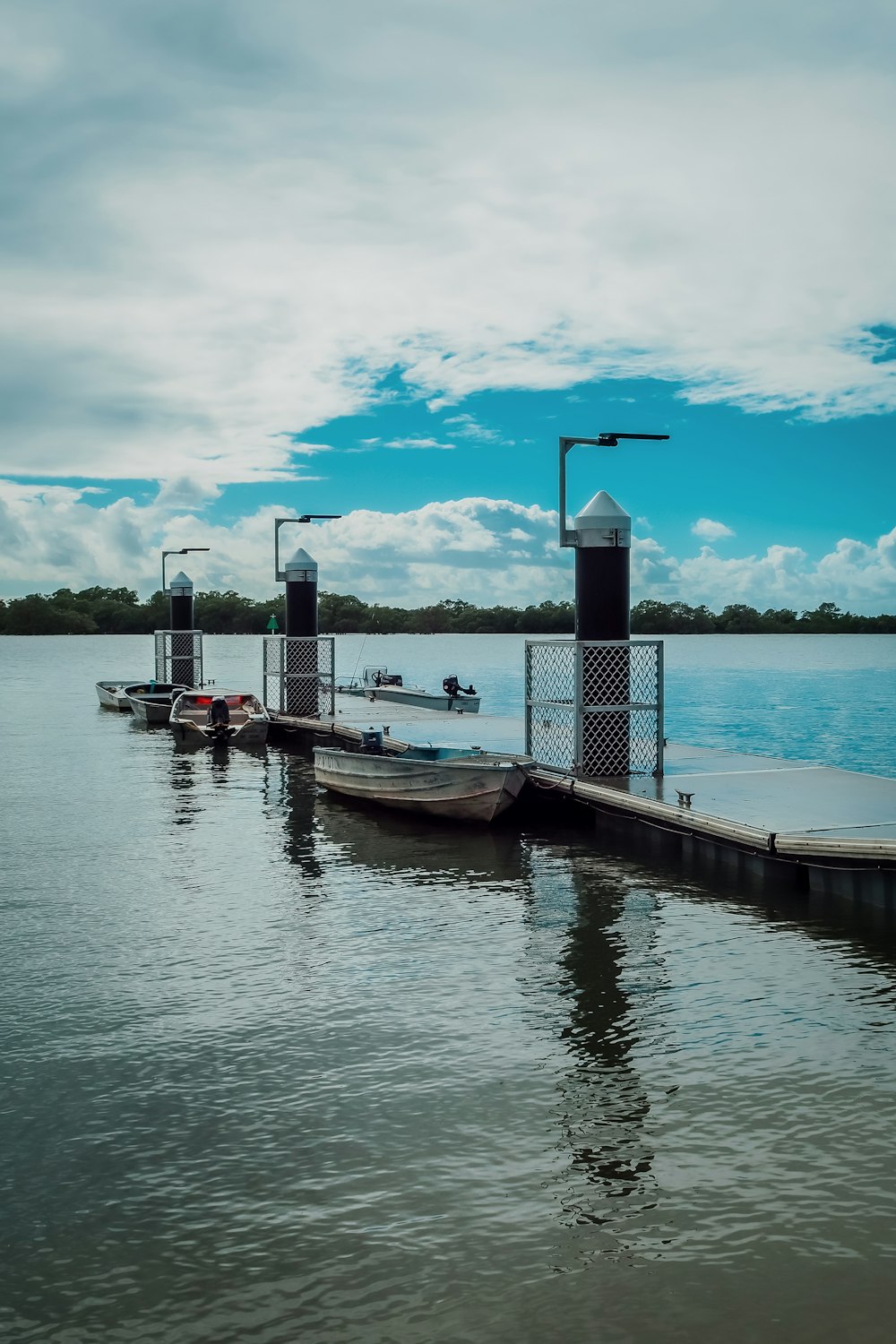 a dock on a lake with several boats in the water