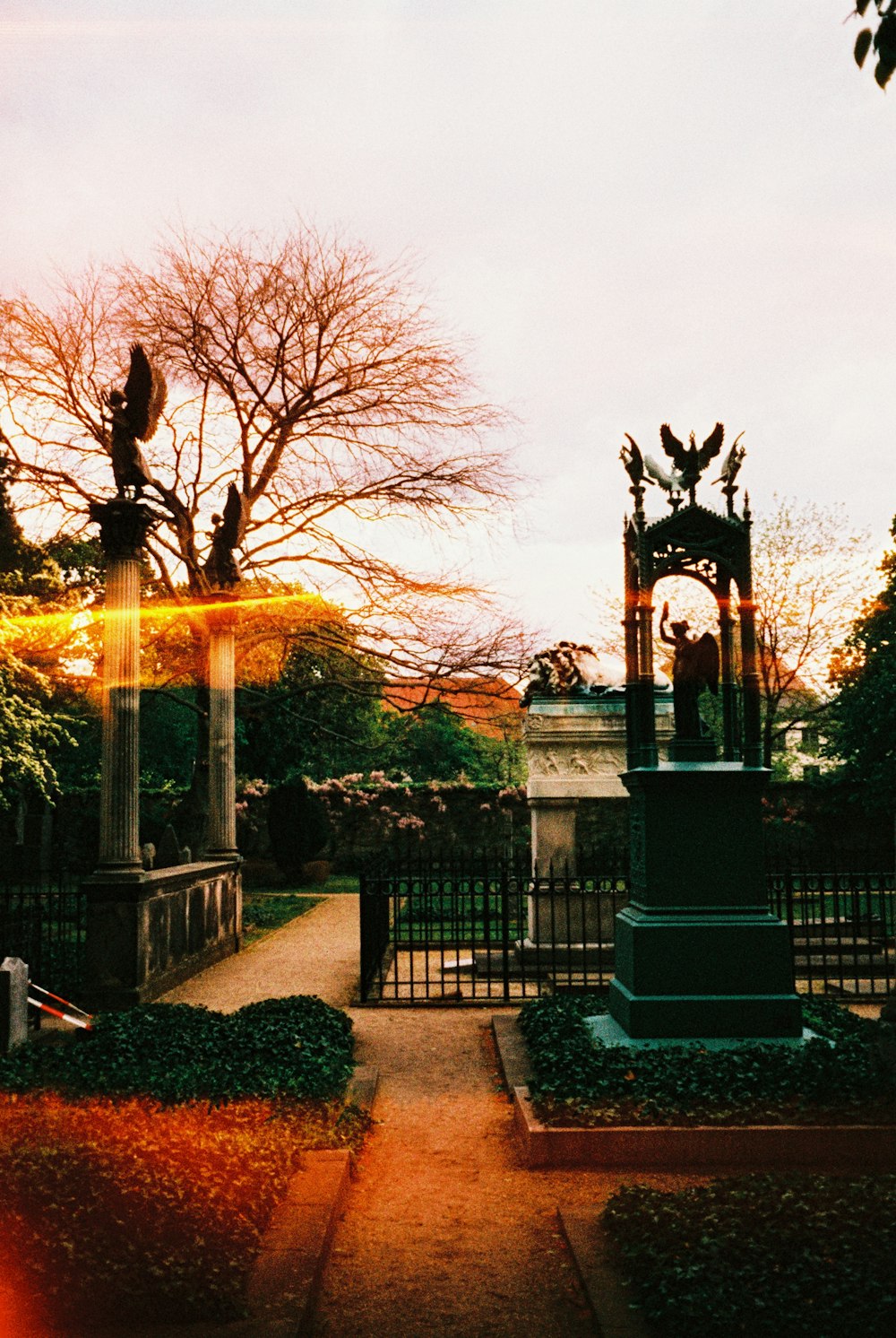 a clock tower in the middle of a garden