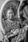 a woman in a turban looking in a mirror