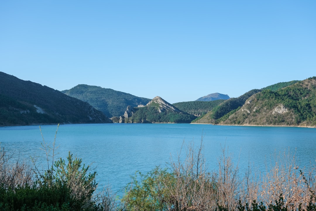 a large body of water surrounded by mountains,