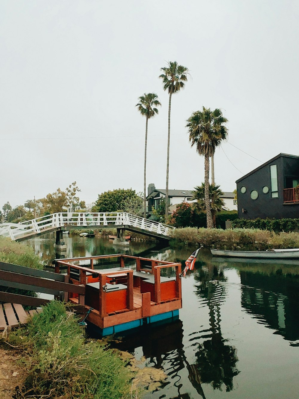 a boat floating on top of a river next to a bridge