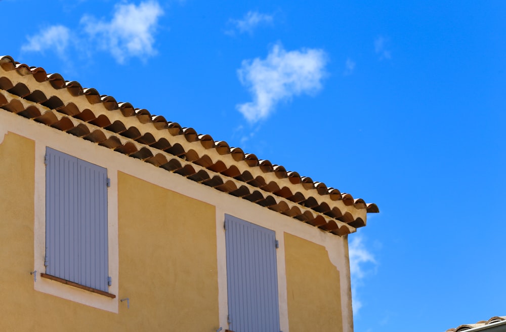 a building with two windows and a sky background