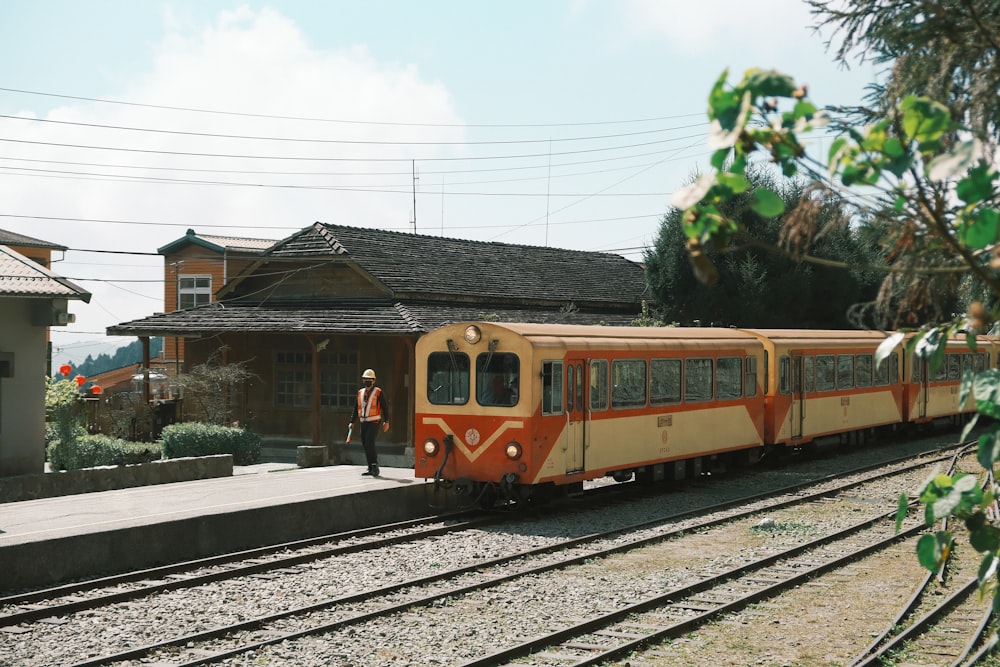 a train on a train track near a building