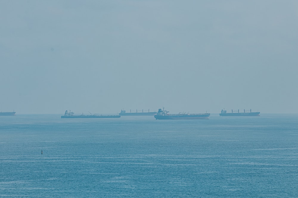 a group of ships floating on top of a large body of water