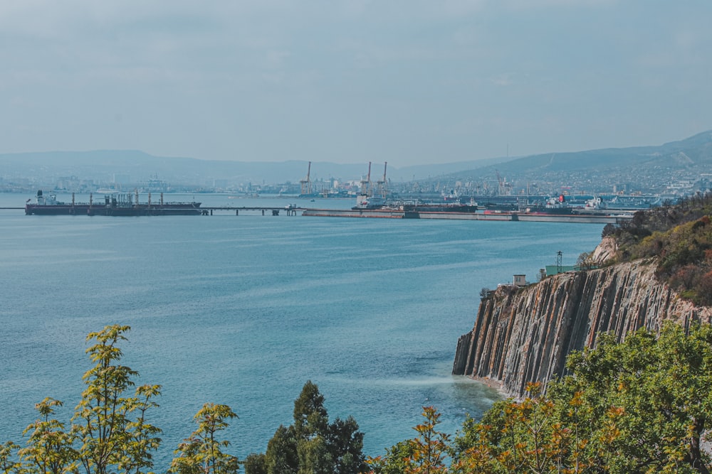 a large body of water with a bridge in the background