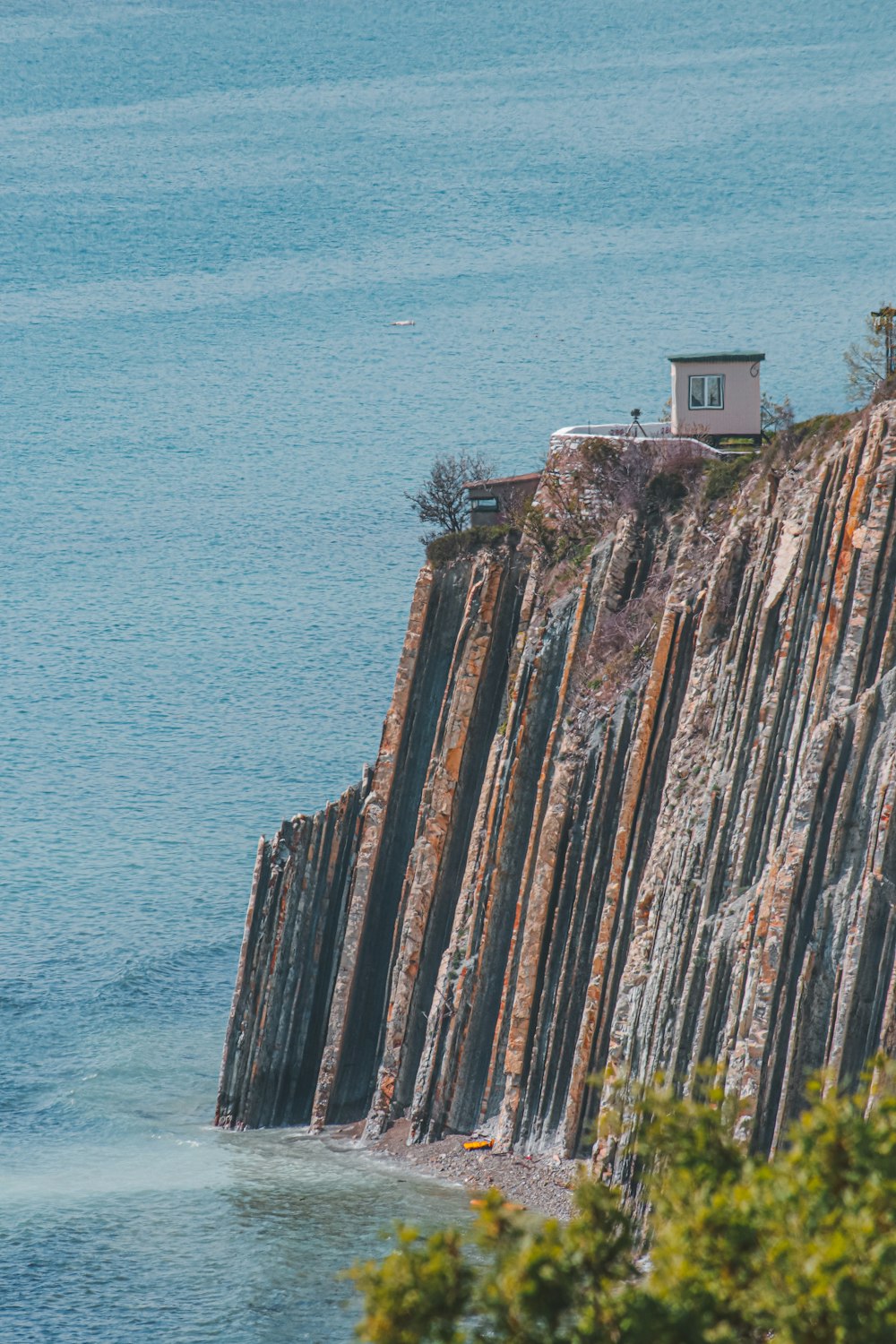 a house on a cliff overlooking the ocean