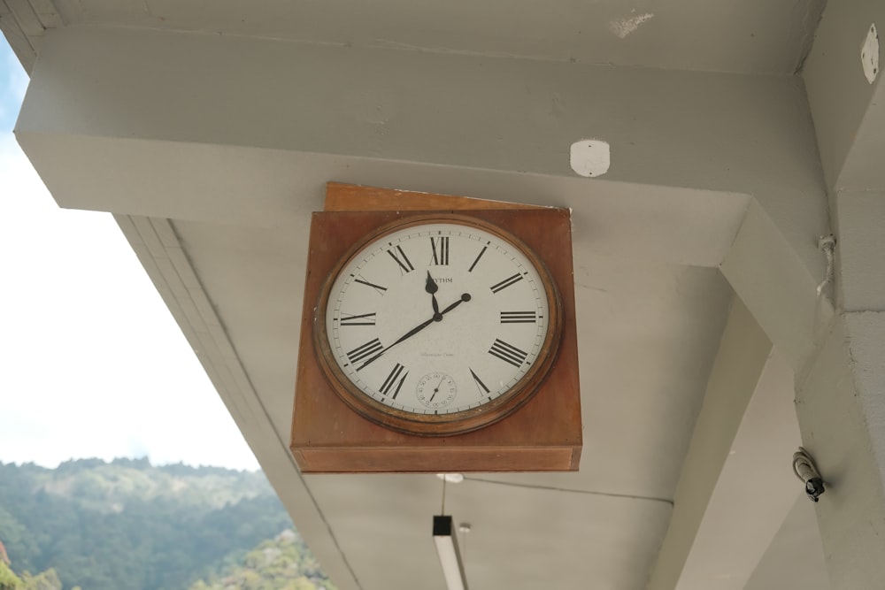 a clock hanging from the side of a building