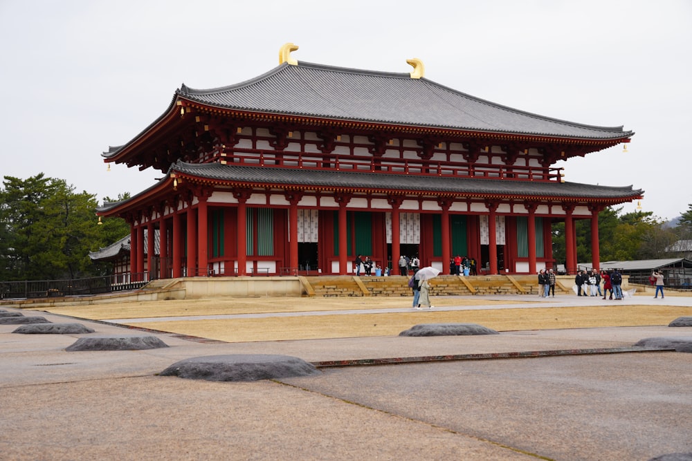 a red and white building with people standing in front of it