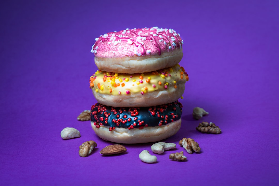 Colorful donuts burger on pastel background.