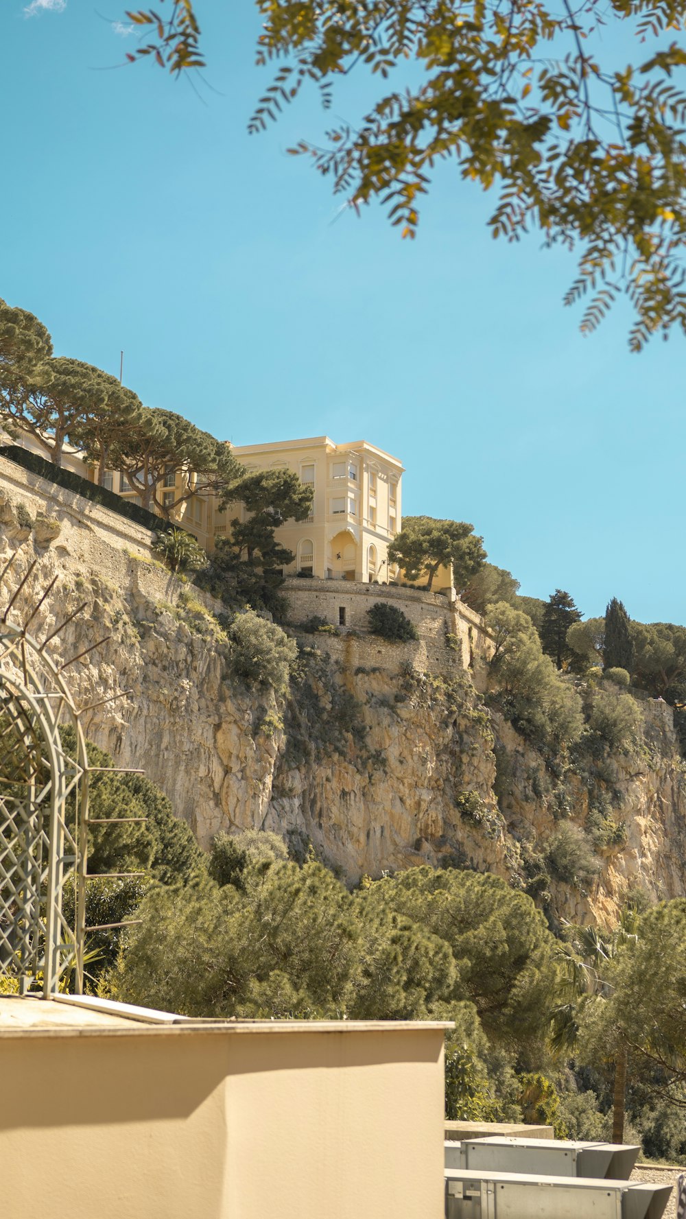 a building on top of a hill with a clock on it