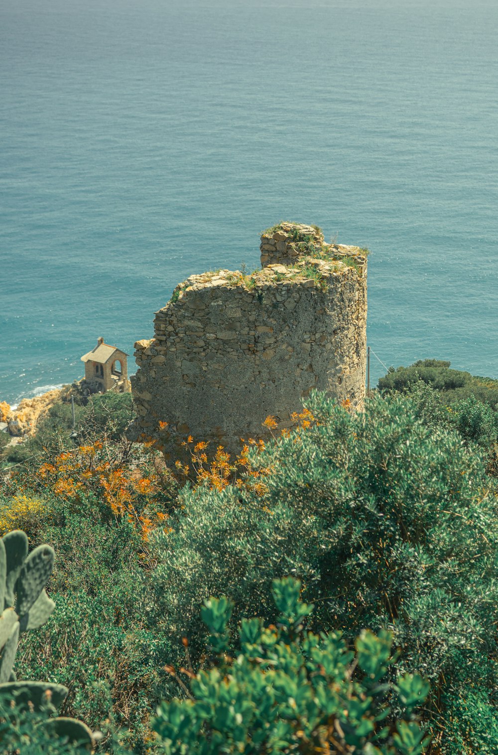 a stone tower on a cliff overlooking the ocean