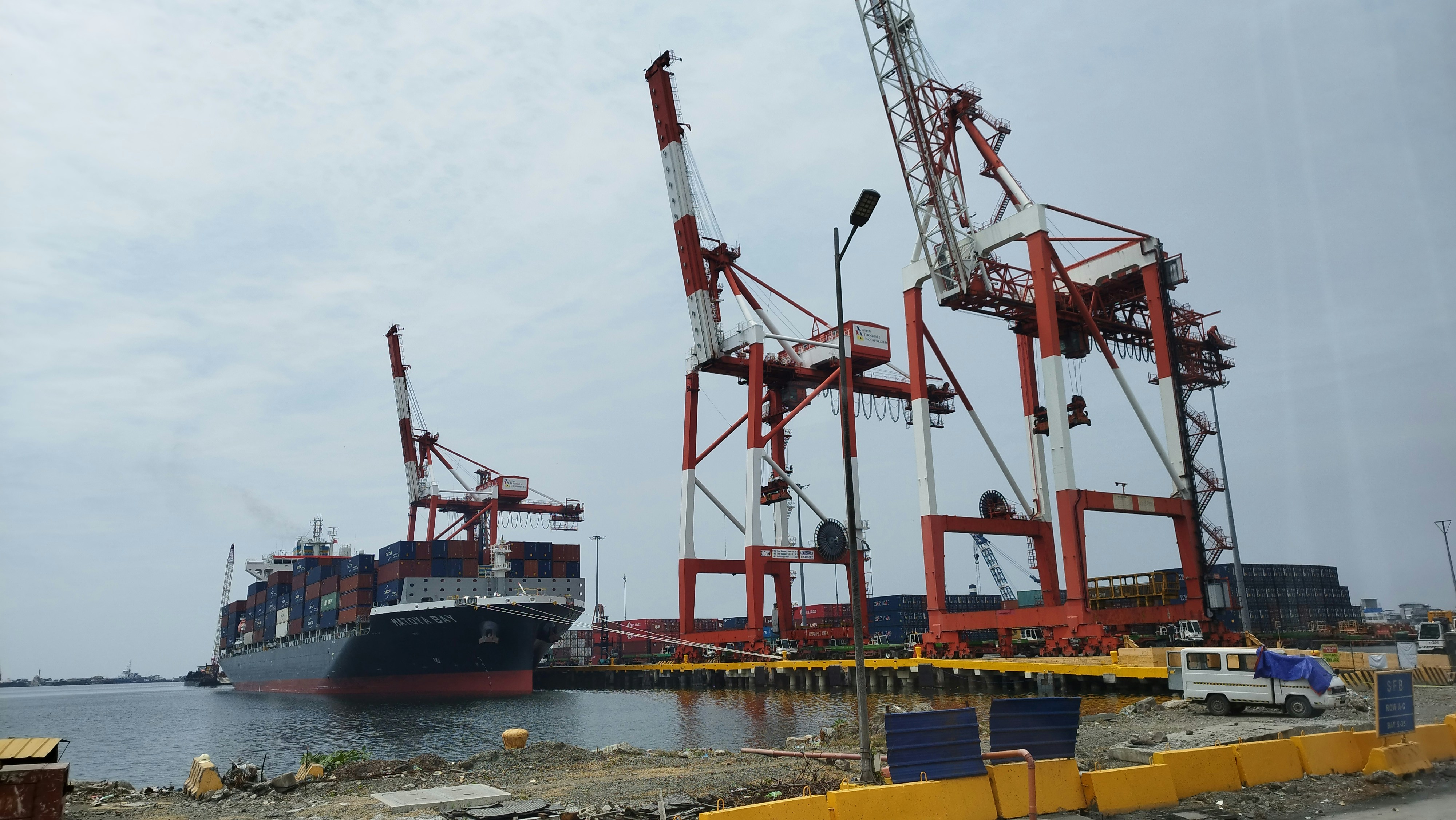 a large boat in the water next to a dock