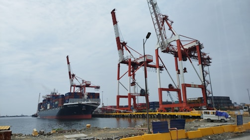 a large boat in the water next to a dock