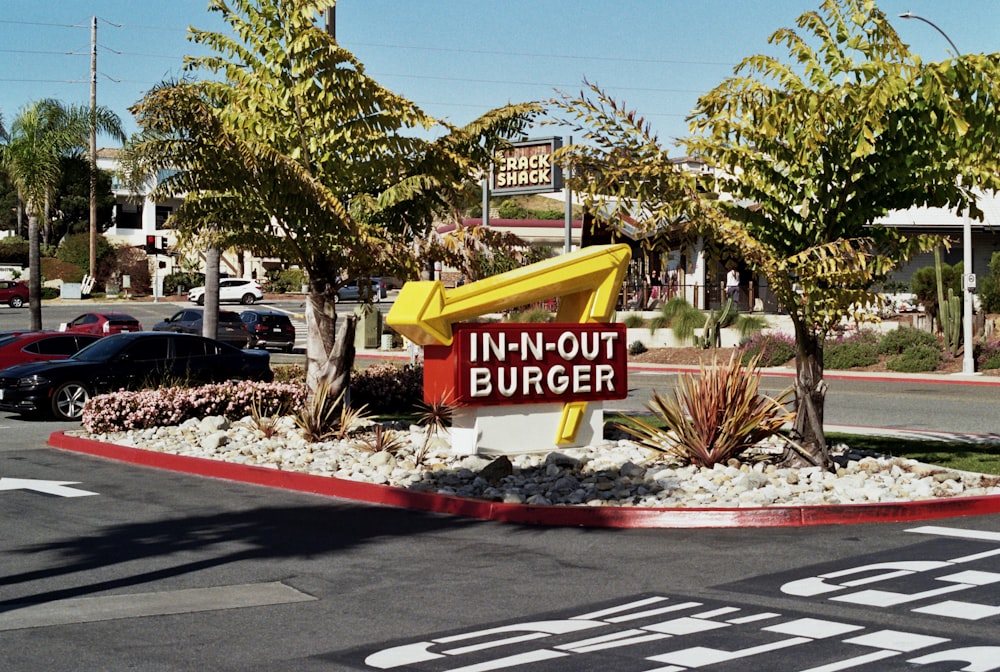 a sign that says in - n - out burger in front of a parking lot