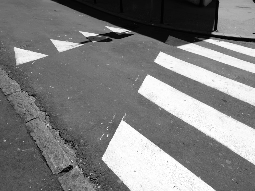 a black and white photo of a cross walk