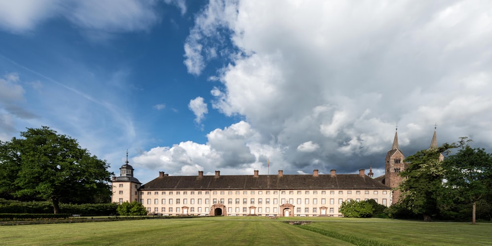 a large building sitting on top of a lush green field