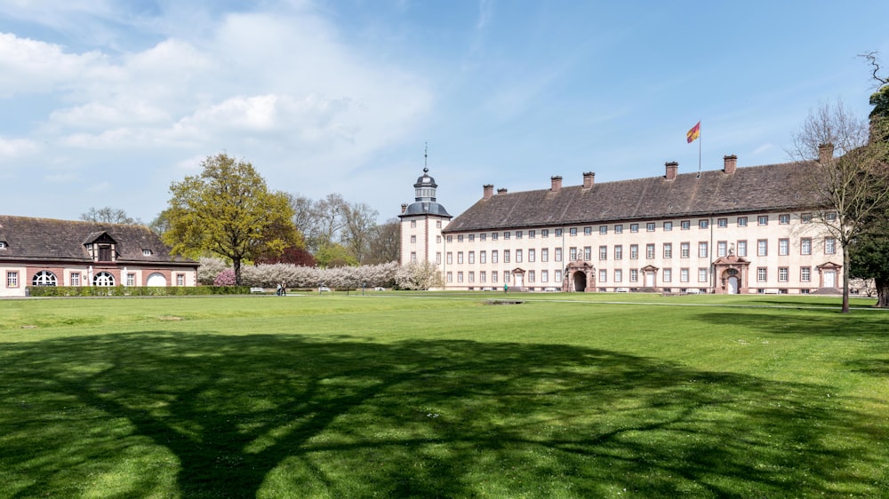 a large building with a lawn in front of it