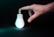 a light bulb being held by a hand