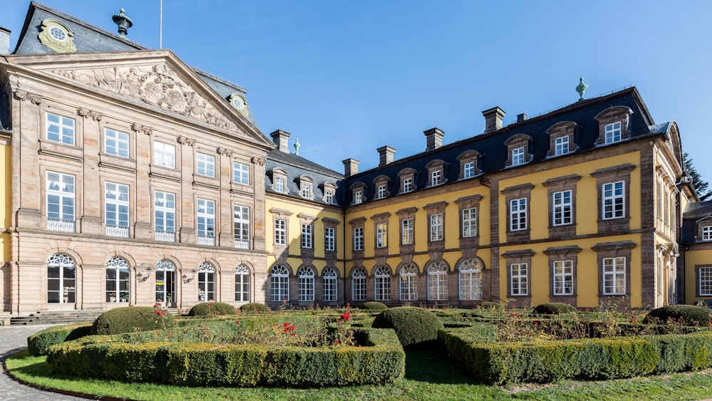 a large building with a garden in front of it