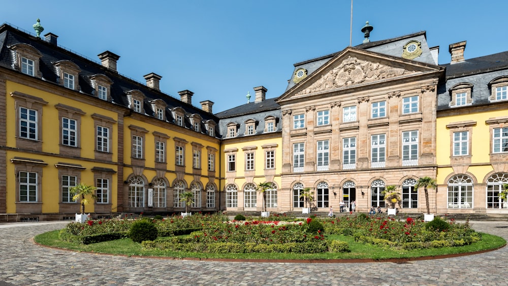 a large building with a circular garden in front of it