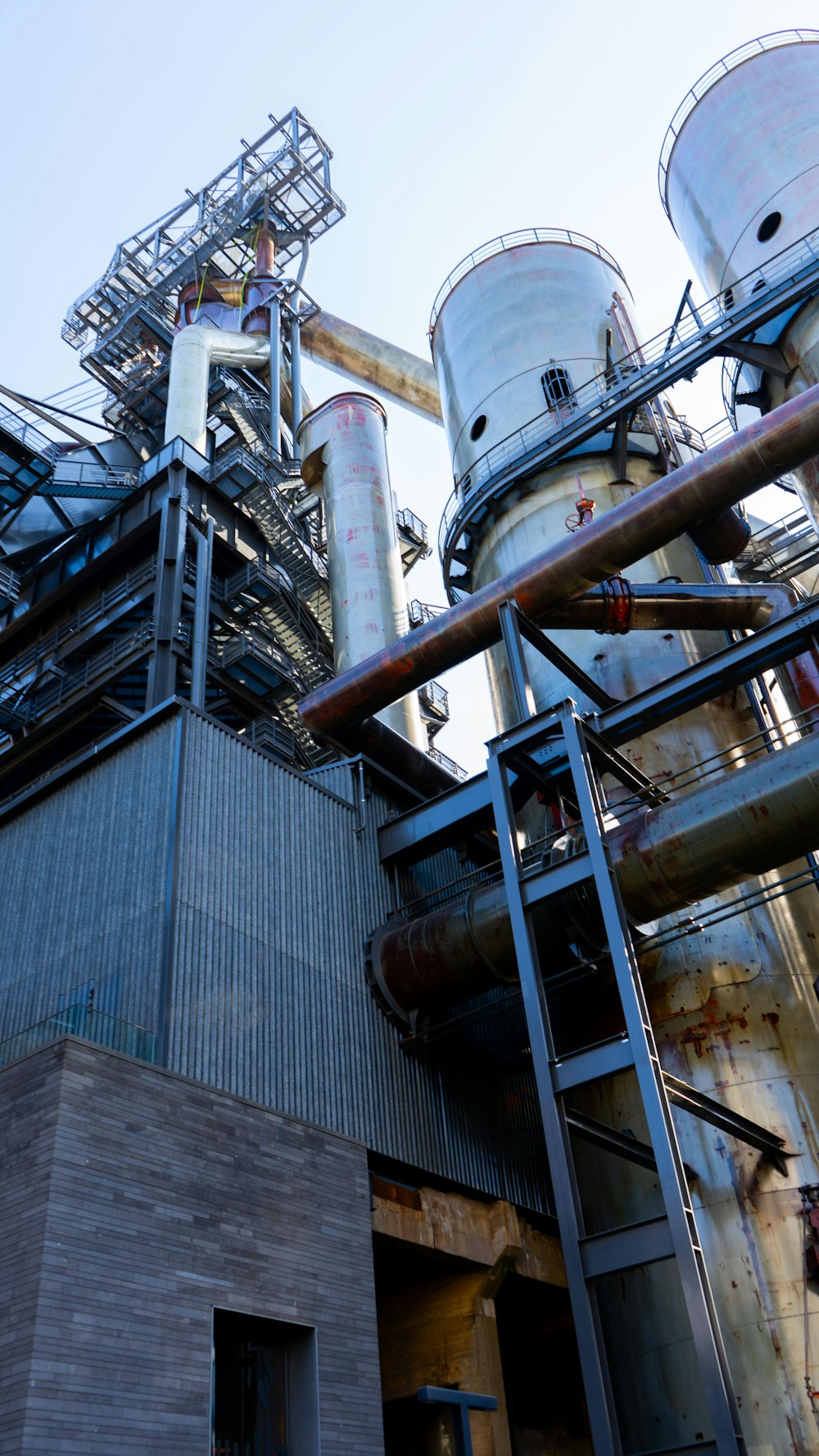 a large industrial building with a lot of pipes