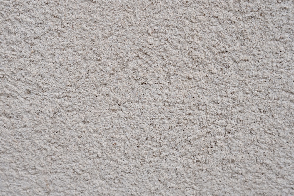 a close up of a white stucco wall