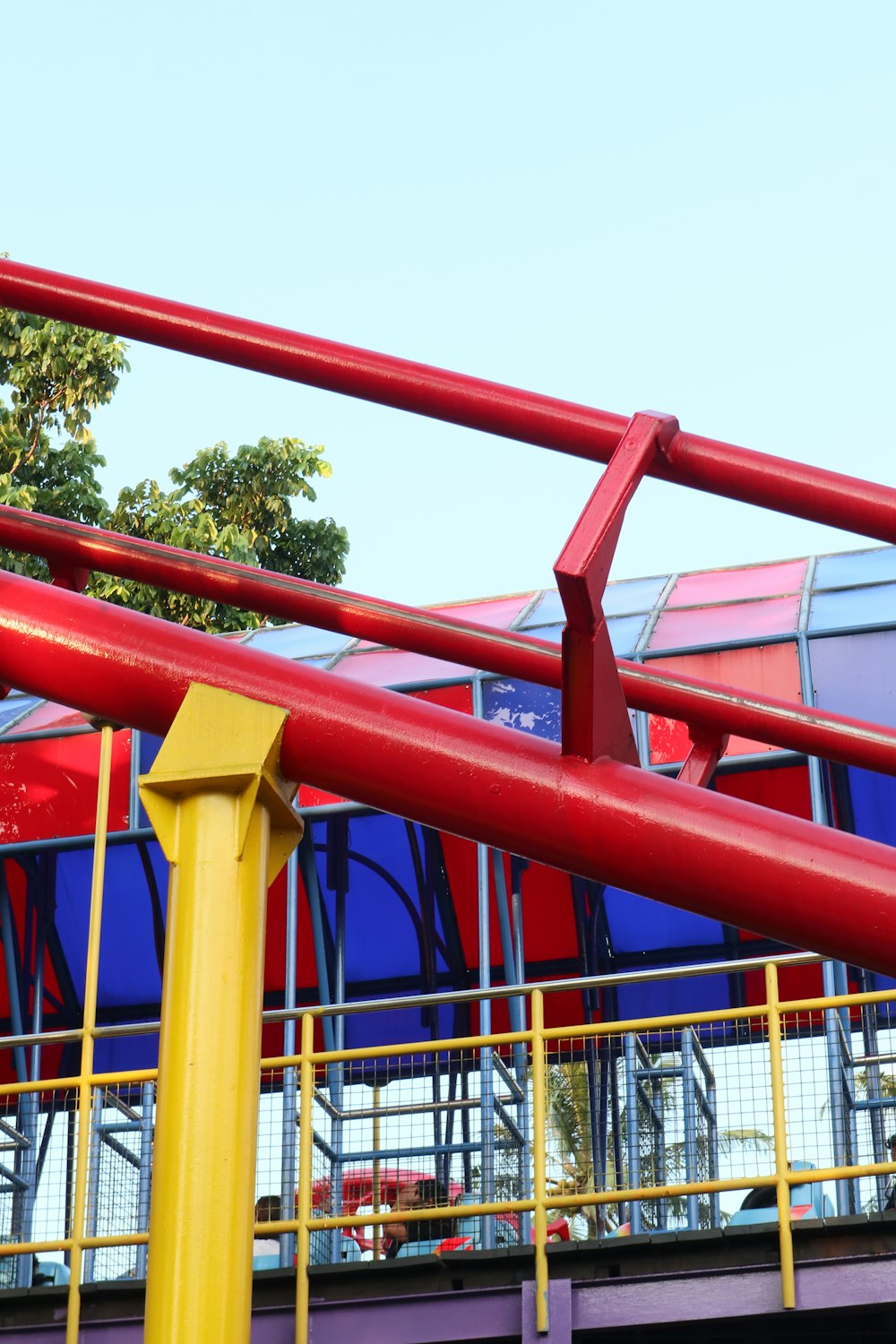 a red and blue double decker bus traveling over a bridge