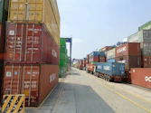a long line of shipping containers on the side of a road
