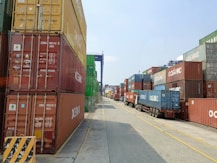 a long line of shipping containers on the side of a road