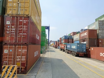 a long line of shipping containers on the side of a road