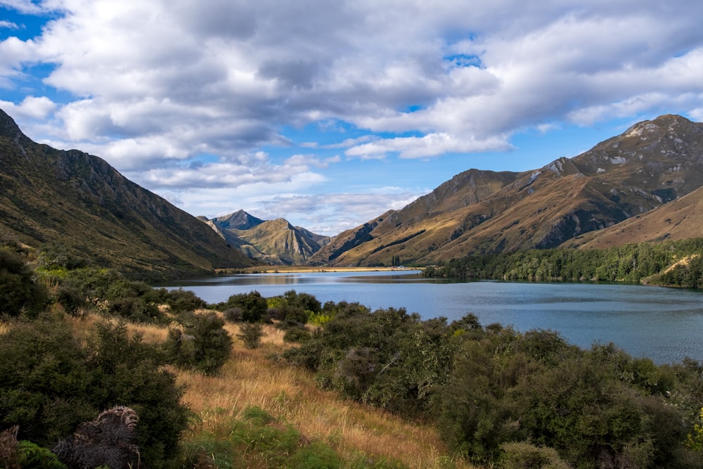 a scenic view of a lake surrounded by mountains